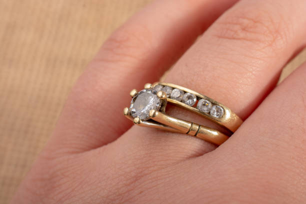 istock Hand wearing a diamond ring on a textured background 1137945551