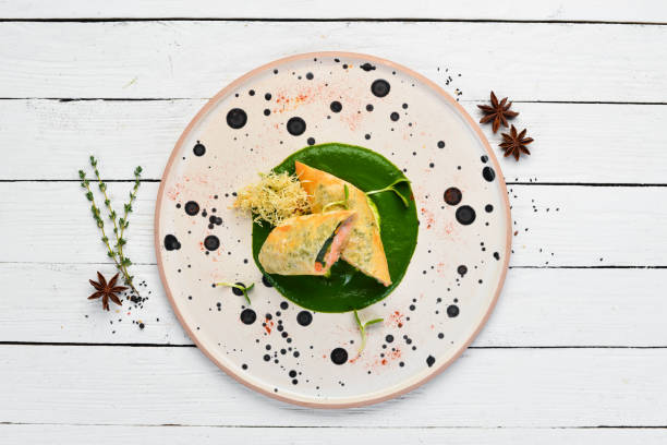 istock Rolls with salmon and spinach. Lavash. In the plate. Top view. Free space for your text. Rustic style. 1137947336
