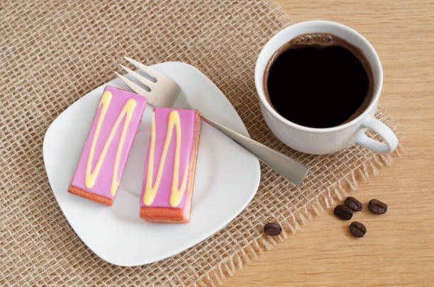 istock Coffee and cake with purple fondant icing 1137948483