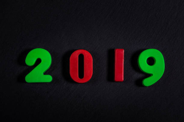 istock Happy New 2019 Year. Colored numbers on a black background. 1137953548