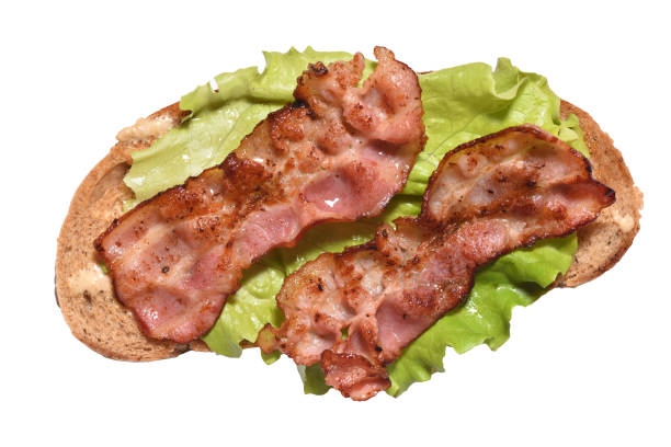 istock Toasted bacon on bread and a leaf of lettuce for breakfast. Close-up 1137954556