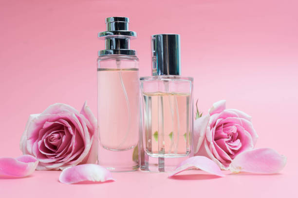 istock Beautiful perfume bottles on pink background 1137959237