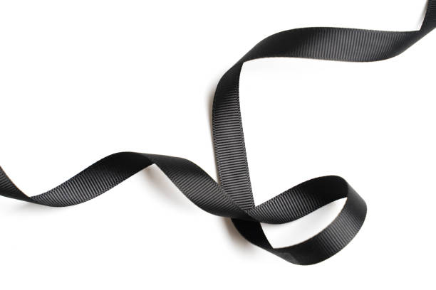 istock Black ribbon in roll on white background 1137959248