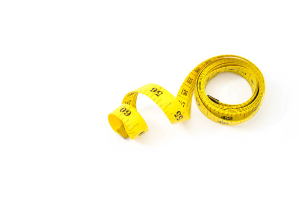 Hand holding tape measure white background