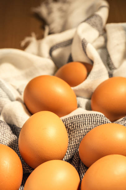 istock Eggs in a towel on a wooden table. 1137961876