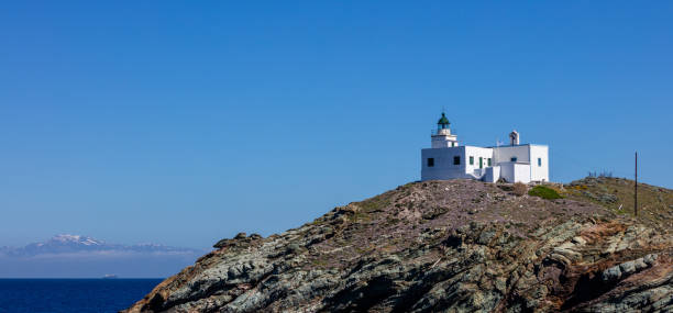 istock Greece, Kea island, Lighthouse on a cave, clear blue sky background 1137962432