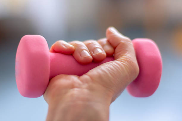 istock a woman  trains with pink dumb bells 1137962507