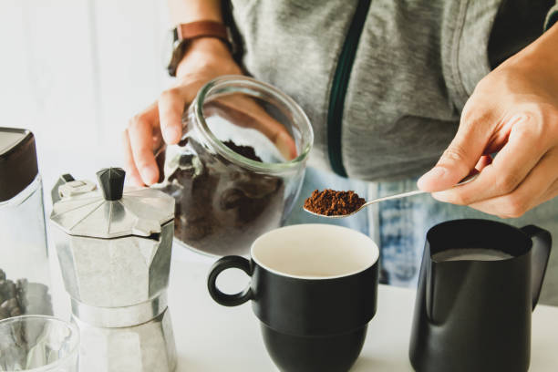 istock Asian man make a cup of coffee on table at home 1137963435