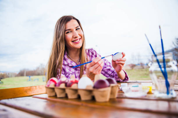 istock Woman holding paintbrush and Easter egg 1137964785