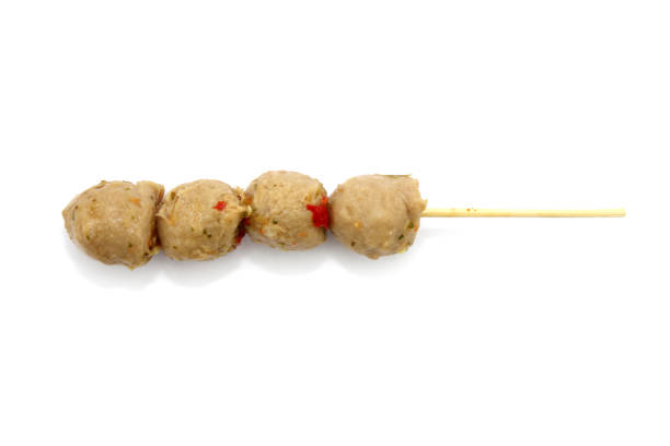 Grilled meat ball with sauce isolated on white.
