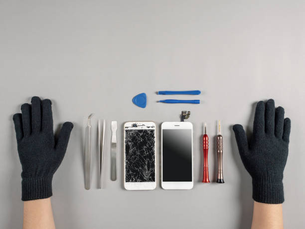 istock Technician repairing broken smartphone on desk 1137965070