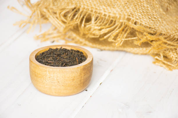 Bunch of dried black tea leaves on clean white background. Naturalness and quality of the product. Tea theme