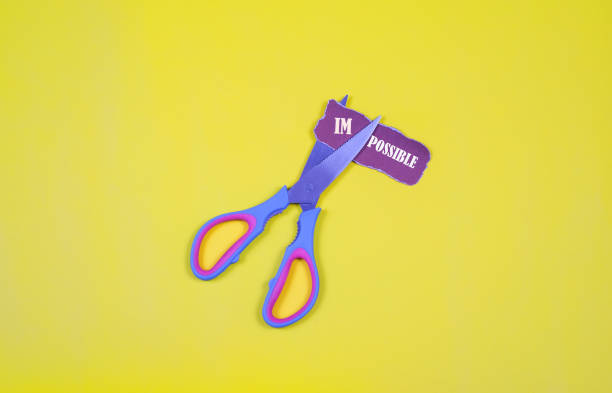 istock Cutting the word im so it written possible.Impossible Is Possible 1137965147