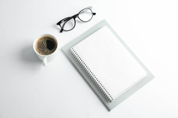istock Copybooks, cup of coffee and glasses on white background, space for text 1137965187