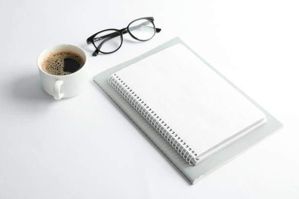 istock Copybooks, cup of coffee and glasses on white background, space for text 1137965205