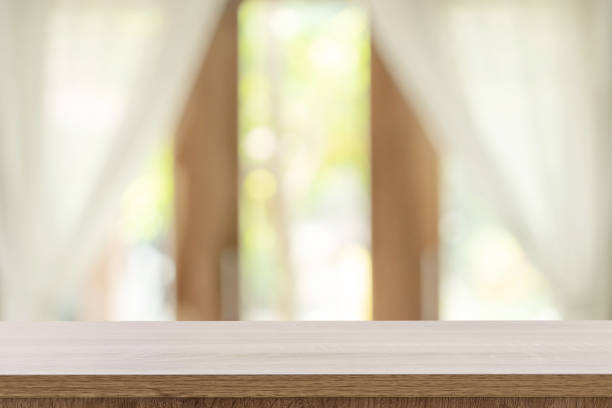 istock Empty wooden table and blur window background with copy space, display montage for product. 1137965216