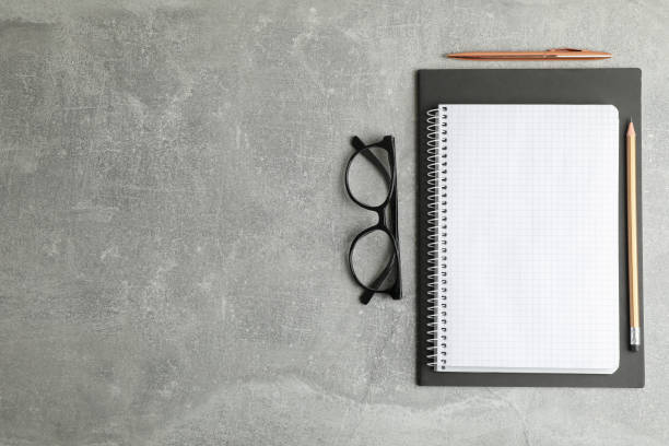 istock Flat lay composition with copybook and glasses, space for text 1137965426