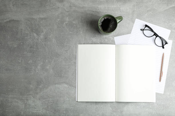 istock Flat lay composition with cup of coffee, copybooks and glasses, space for text 1137965458