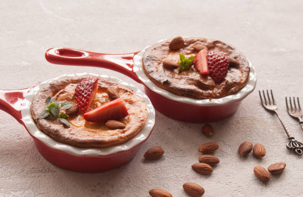 istock Homemade cottage cheese pudding or casserole with strawberries and almonds in small ceramic pans. 1137965559