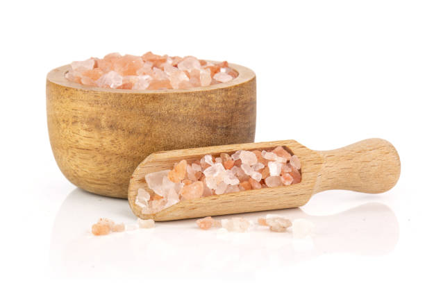 Pink himalayan salt crystals isolated on white