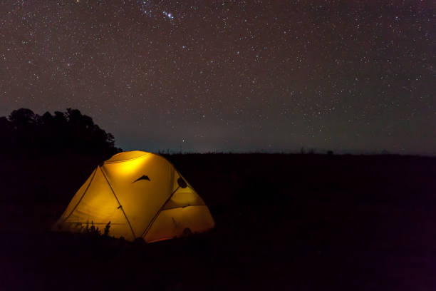istock Yellow lighten tent under night starry sky. 1137968122
