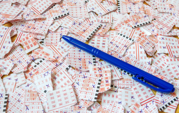 istock Pen on pieces of torn and filled lottery coupons. Sweepstakes. Concept image. Selective focus. 1137968209
