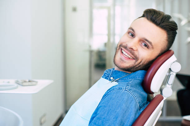 istock Draw the eye. A man is smiling while having a qualified dental treatment in a professional clinic. 1137969533