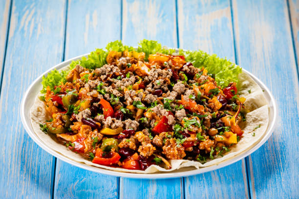 istock Pork meat, nachos and vegetables on wooden background 1137972273