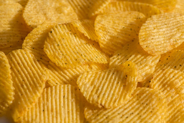 istock Handful of yellow potato chips 1137972417