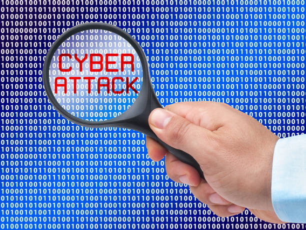 istock magnifying glass in hand on digital background detecting Cyber Attack 1137972681