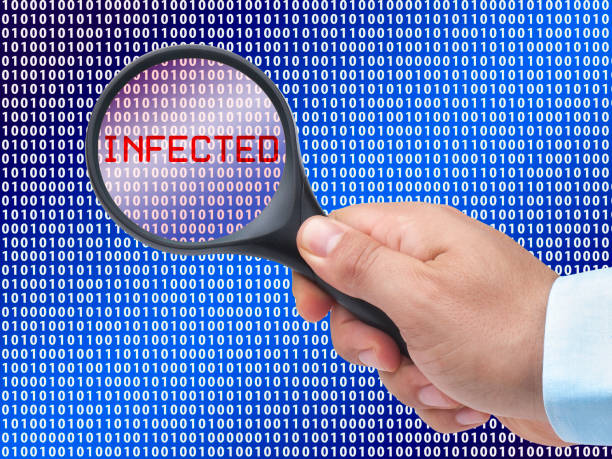 istock magnifying glass in hand on digital background detecting infection 1137972689