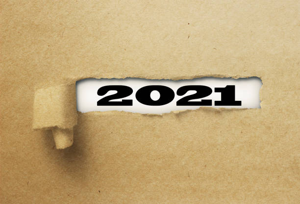 istock ripped or torn paper revealing new year 2021 on white background 1137972714
