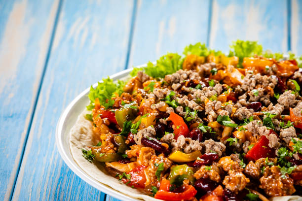 istock Pork meat, nachos and vegetables on wooden background 1137972800
