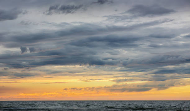 istock sunset in the cloudy sky over the sea 1137973397