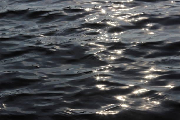istock Background of water waves, reflecting sun, light rays 1137975066
