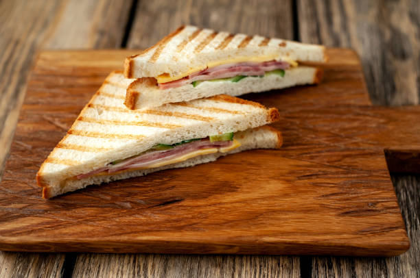 istock Two sandwiches on a cutting board on a wooden background in a rustic style. view from above 1137975124