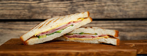 istock Two sandwiches on a cutting board on a wooden background in a rustic style. view from above 1137975131
