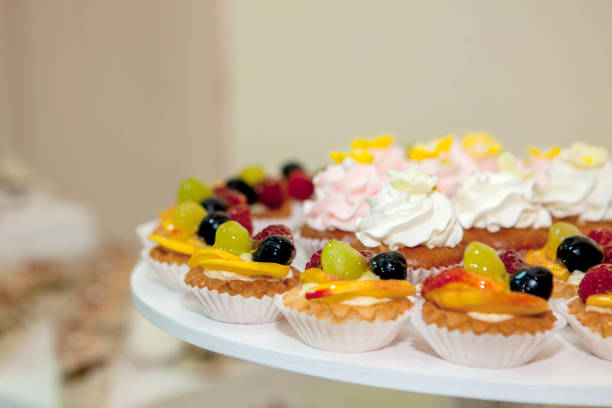 istock cupcakes with raspberries, grapes and peach on a wedding table 1137975185