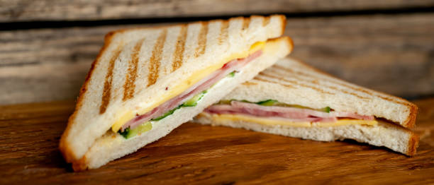 istock Two sandwiches on a cutting board on a wooden background in a rustic style. view from above 1137975213