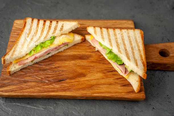 istock two sandwiches on a cutting board, on a concrete background 1137975234