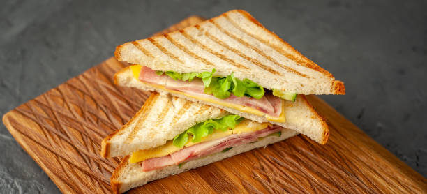 istock two sandwiches on a cutting board, on a concrete background 1137975241