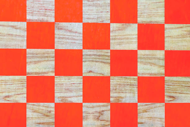 istock Wooden chessboard with orange cells. Checkerboard background. 1137975461