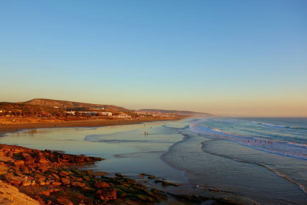 Sunrise over coastal village Taghazout in Southern Morocco known as surfing paradise near to Agadir Sunrise over coastal village Taghazout in Southern Morocco known as surfing paradise near to Agadir, Africa sunset agadir marocco stock pictures, royalty-free photos & images
