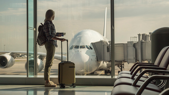 Image of hand luggage in the airport terminal with morning sunlight