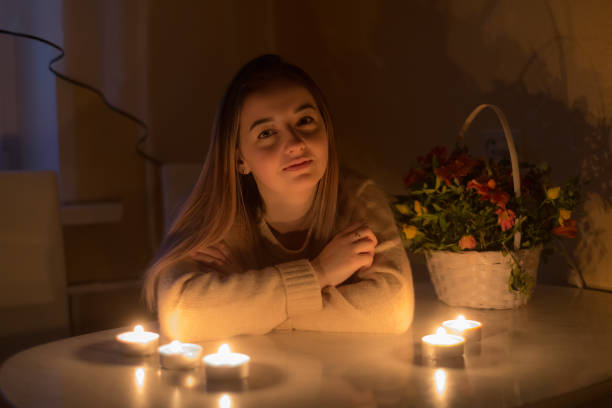 istock girl at the table with candles 1137977709