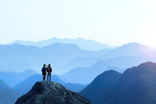 hiker femenino y masculino tomando la imagen de sunset - pico montaña fotos fotografías e imágenes de stock