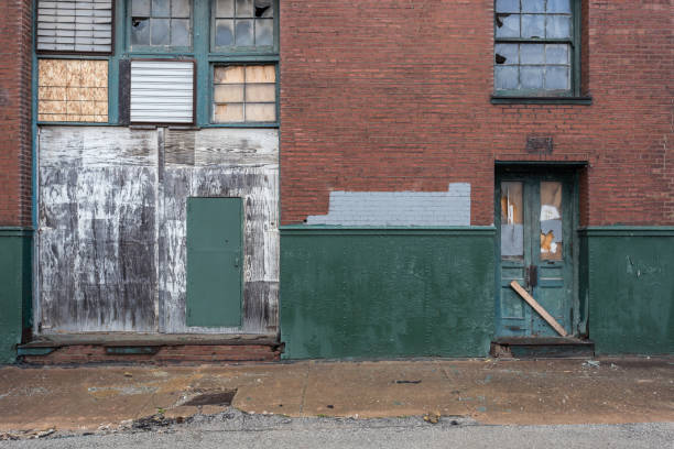 istock Various boarded doors and windows of a vintage abandoned red brick factory 1137979392
