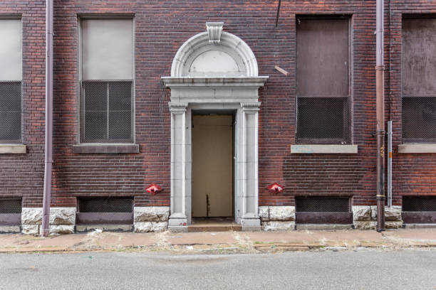 istock Dark red brick factory with decorative entrance left abandoned 1137979452