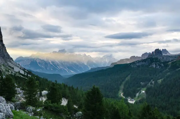 Rocky mountains in Italian Dolomites, lit with the first beam of light. View from the other side of the valley.