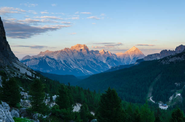 Rocky mountains in Italian Dolomites, lit with the last light of the day. View from the other side of the valley.